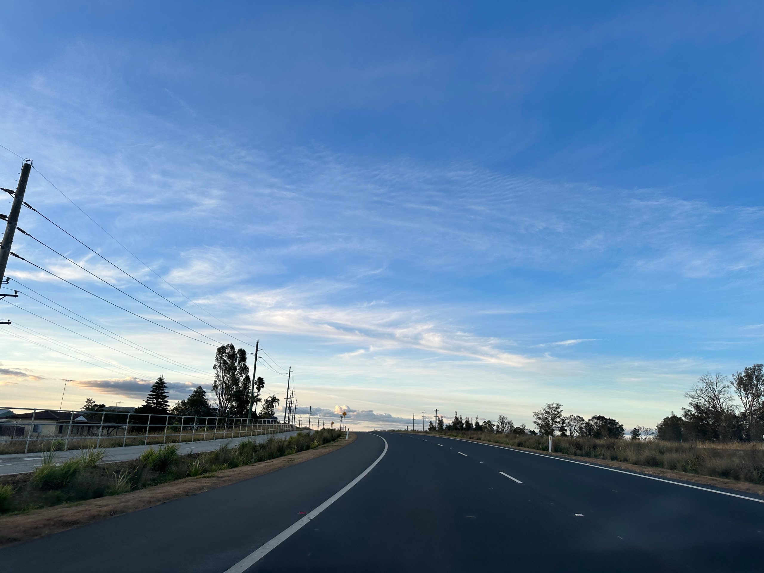 The Northern Road at the Mulgoa and Orchard Hills boundary, with open roadside grass and trees