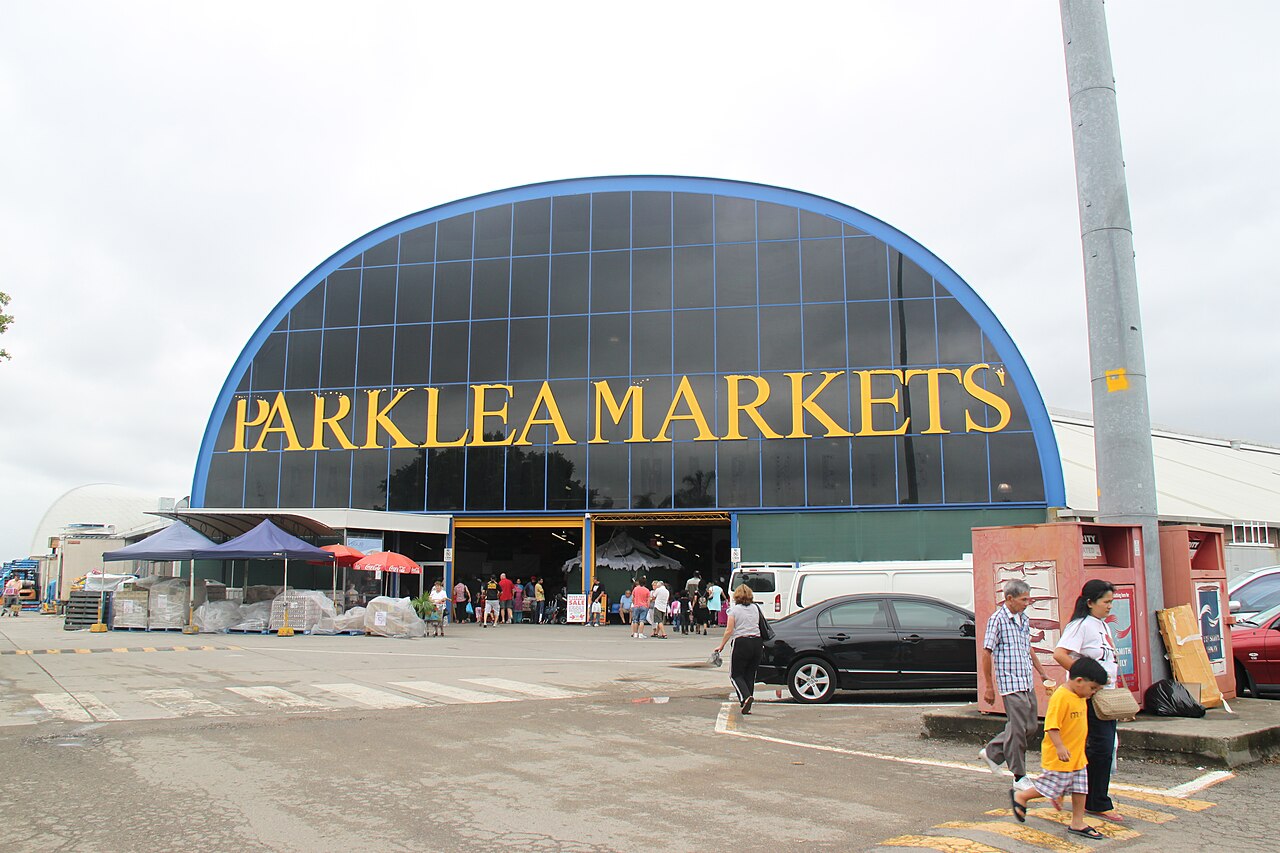 Parklea Markets entrance with visitors and parked vehicles in a 2009 photograph
