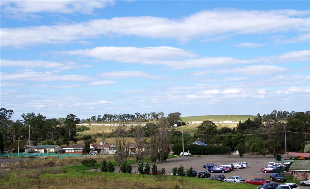 Houses, parked cars and a grassy rise in a 2007 view of Rooty Hill