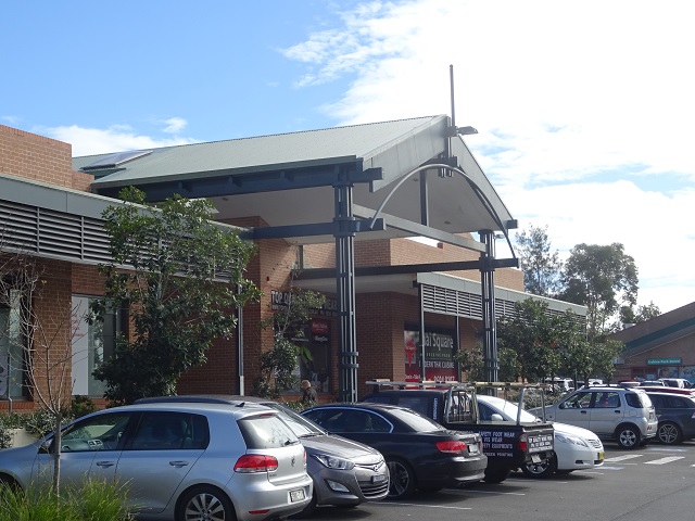 Erskine Park shopping centre with parked cars and a covered entrance