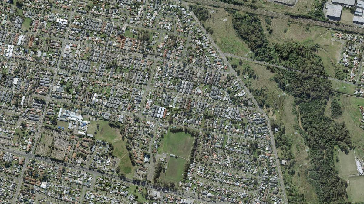 Aerial photograph centred on Oxley Park showing residential streets, sports fields and open corridors